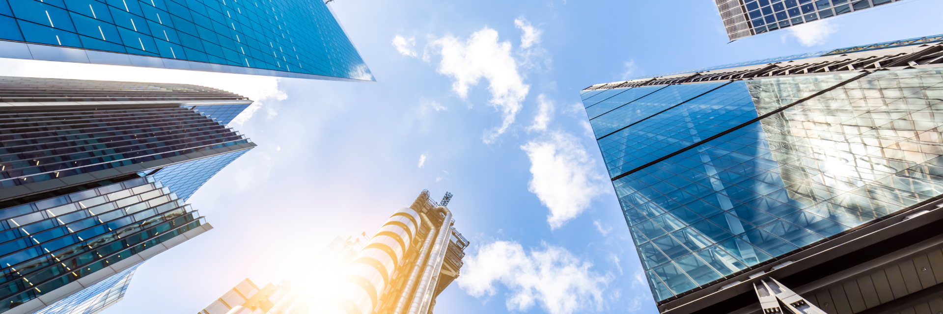 Skyscrapers against a blue sky with clouds