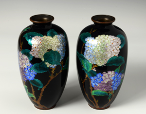 Two cloisonne vases with a dark background and floral design