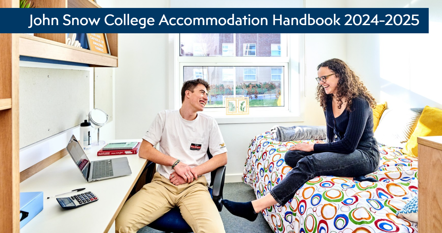 Front cover of John Snow Accommodation Handbook showing 2 students sitting talking in a student bedroom.