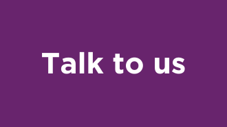 White text on a purple background. The text reads 'Talk to us'.