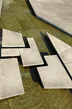 Manmade angular stepping stones in a manmade water feature