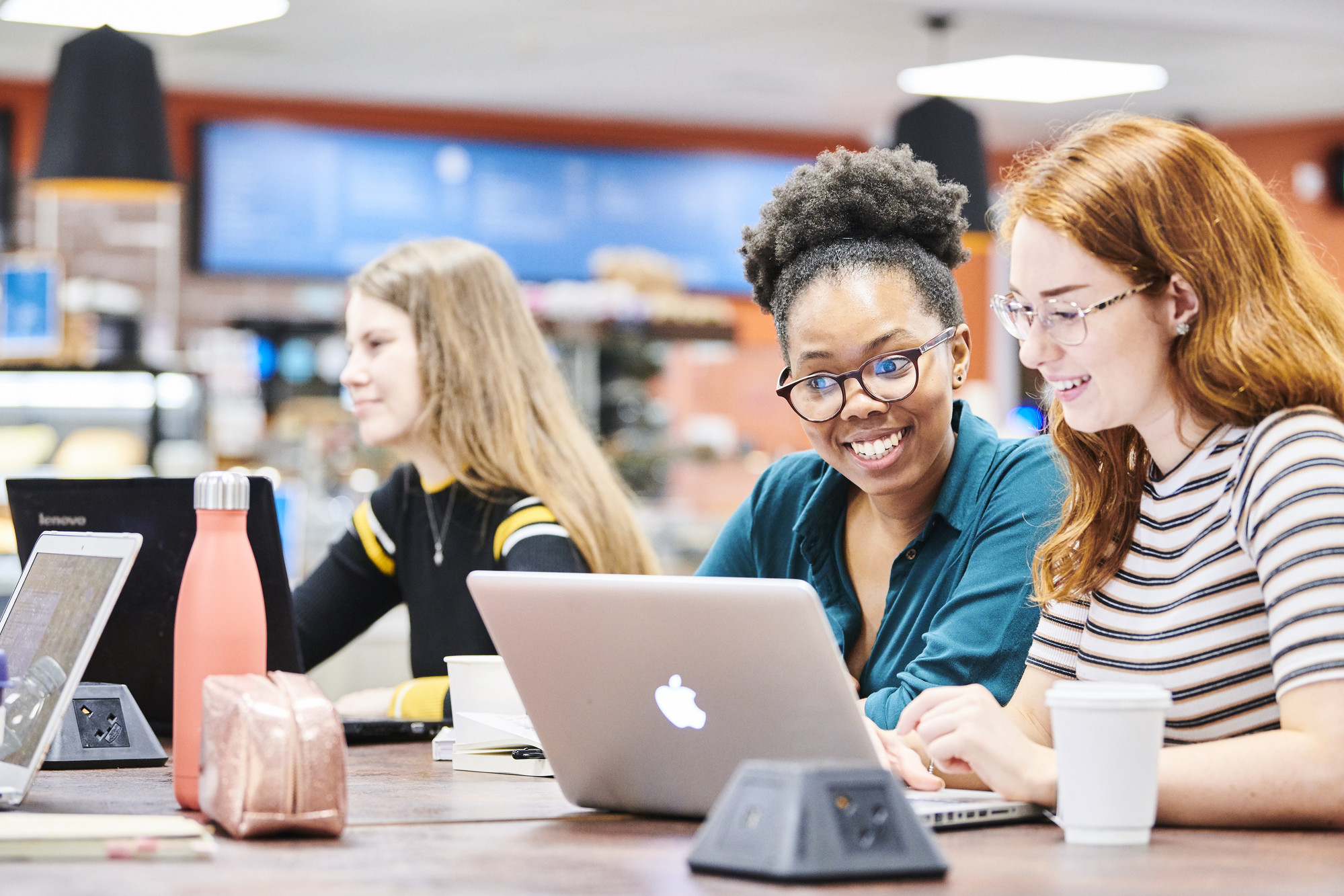 Students working on laptop in Bill Bryson Library café