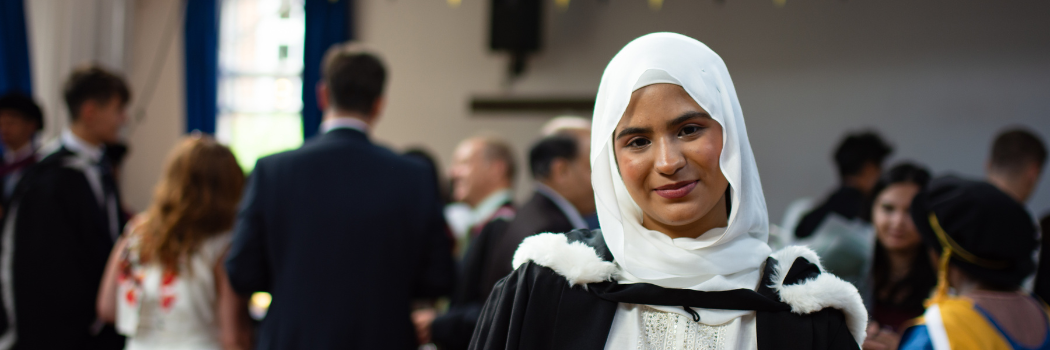 Young woman wearing white hijab and smiling to camera