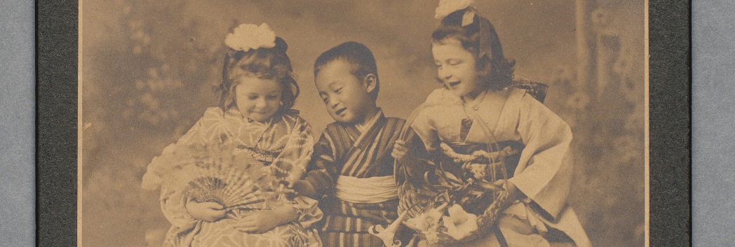 Dorothy and Margaret Squires with a member of the Japanese family, children in Japanese dress, black and white image