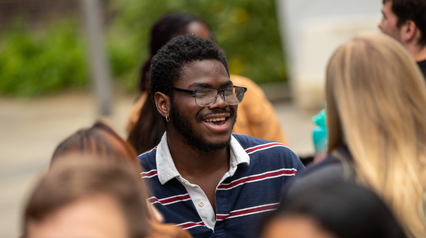 Student smiling outside on campus