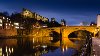 A view of the cathedral, the bridges and the river by night