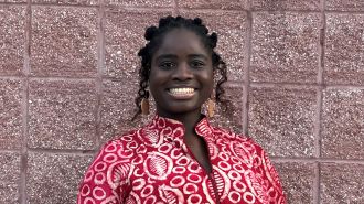 Tinu in red dress smiling