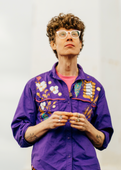 Michael Pedersen from waist up, wearing a purple embroidered shirt