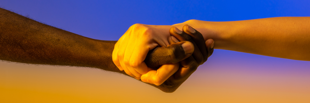 Two hands holding one another in the colours of the Ukrainian flag