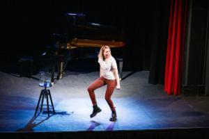 A student performing on stage at the Assembly Rooms Theatre