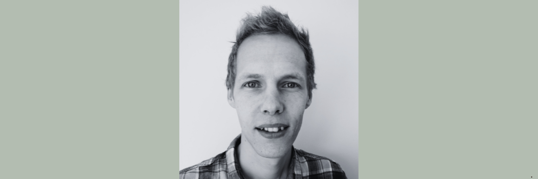 Black and white image of Dr Alistair Brown facing the camera