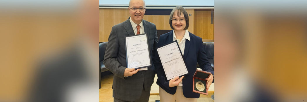 Professor Stefanie Reissner and Professor Rudolf Sinkovics smiling to camera and holding their fellowship certificates