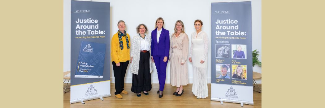 Five women standing between two pull-up banners