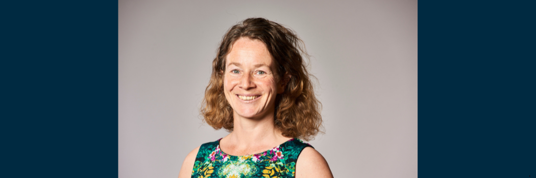 Professor Karen Johnson smiling into the camera against a neutral backdrop