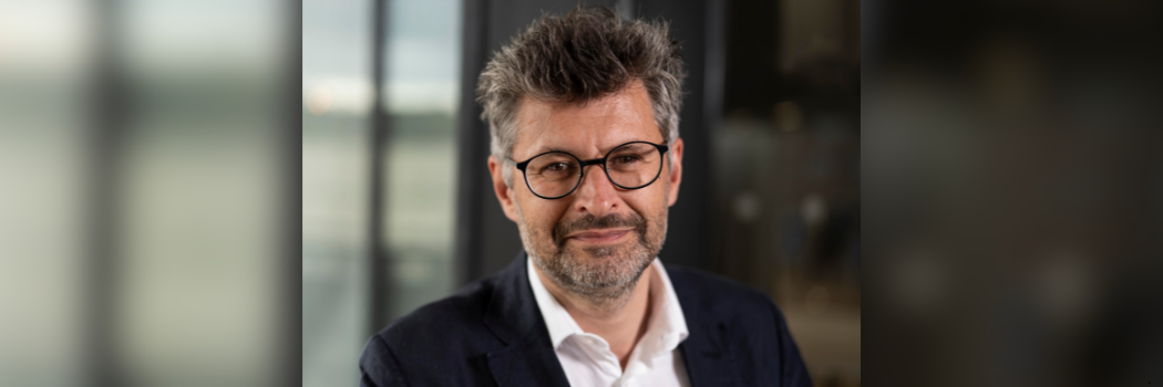 Professor Markian Prokopovych smiling and facing the camera with a blurred background