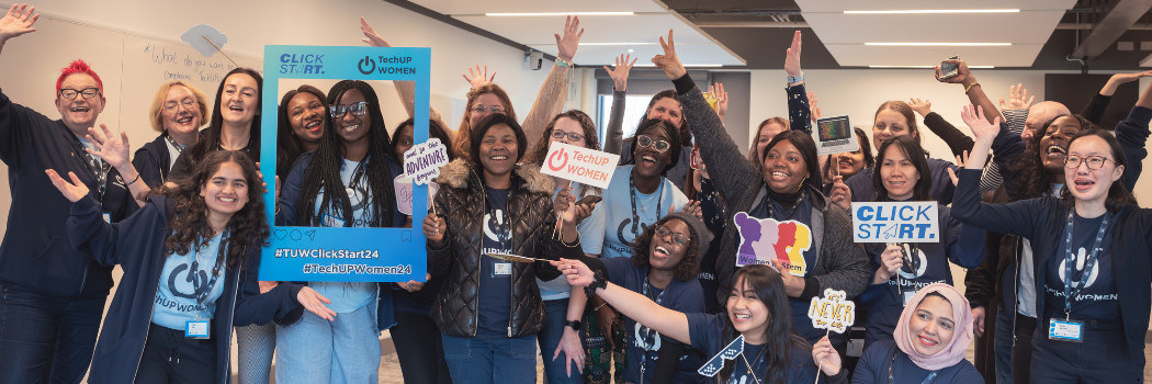Participants in the TechUp programme pose in celebration with comical props and arms raised