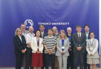A group of people standing in front of banners at Tohoku University