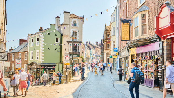 TA street in Durham, with old buildings and people walking down the street