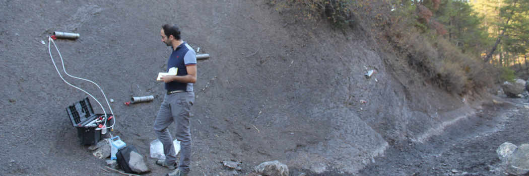 Postdoctoral researcher Guillaume Soulet studying the rocks