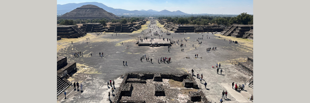 A large ancient outdoor plaza featuring ruins of grey stone walls