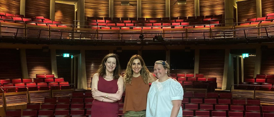 Edith Hall, Magdalena Zira and Arlene Holmes-Henderson standing on stage in Cyprus National Theatre