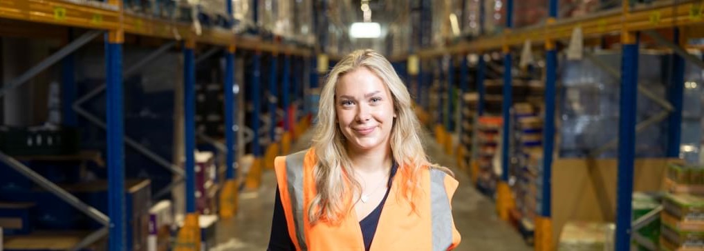 Blonde female student intern in Aldi warehouse