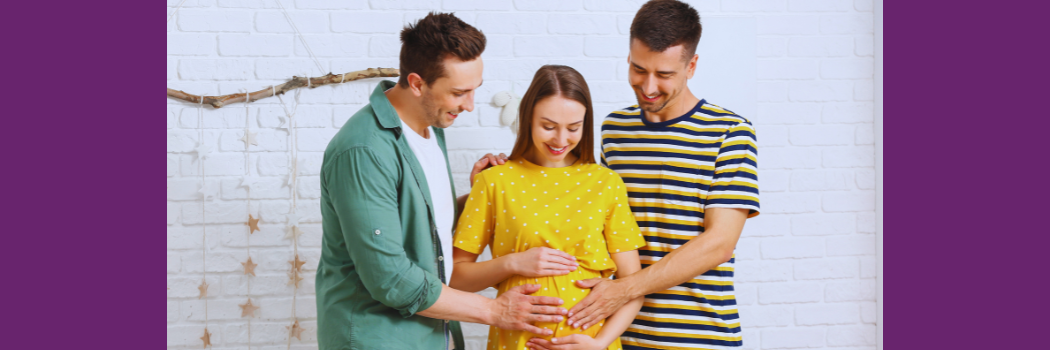 Two men stand beside a pregnant woman cradling her belly.