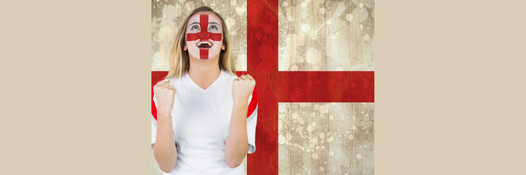 A female football fan wearing England face paint in front of an England flag
