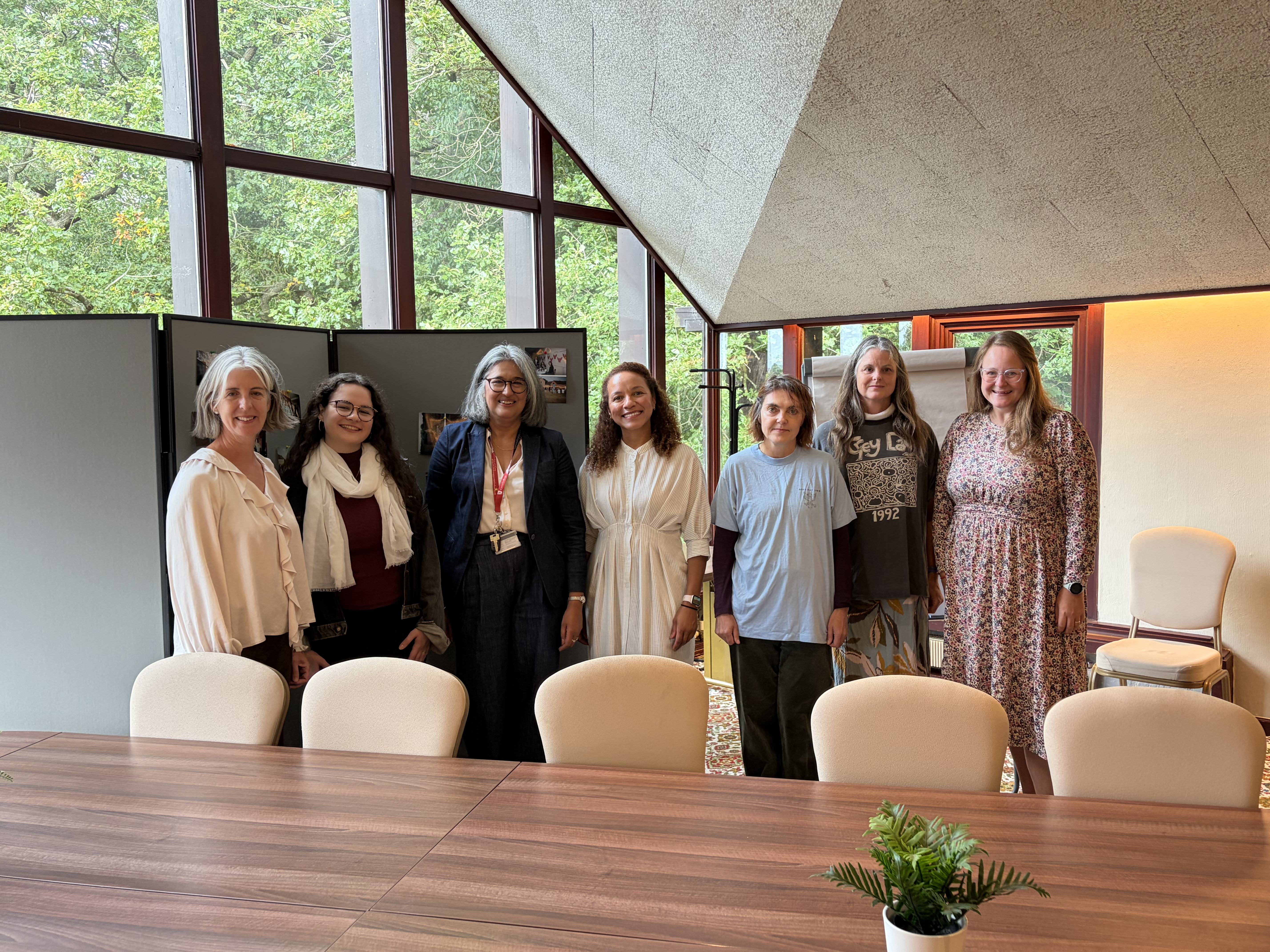 Grey Principal with a group of female alumni