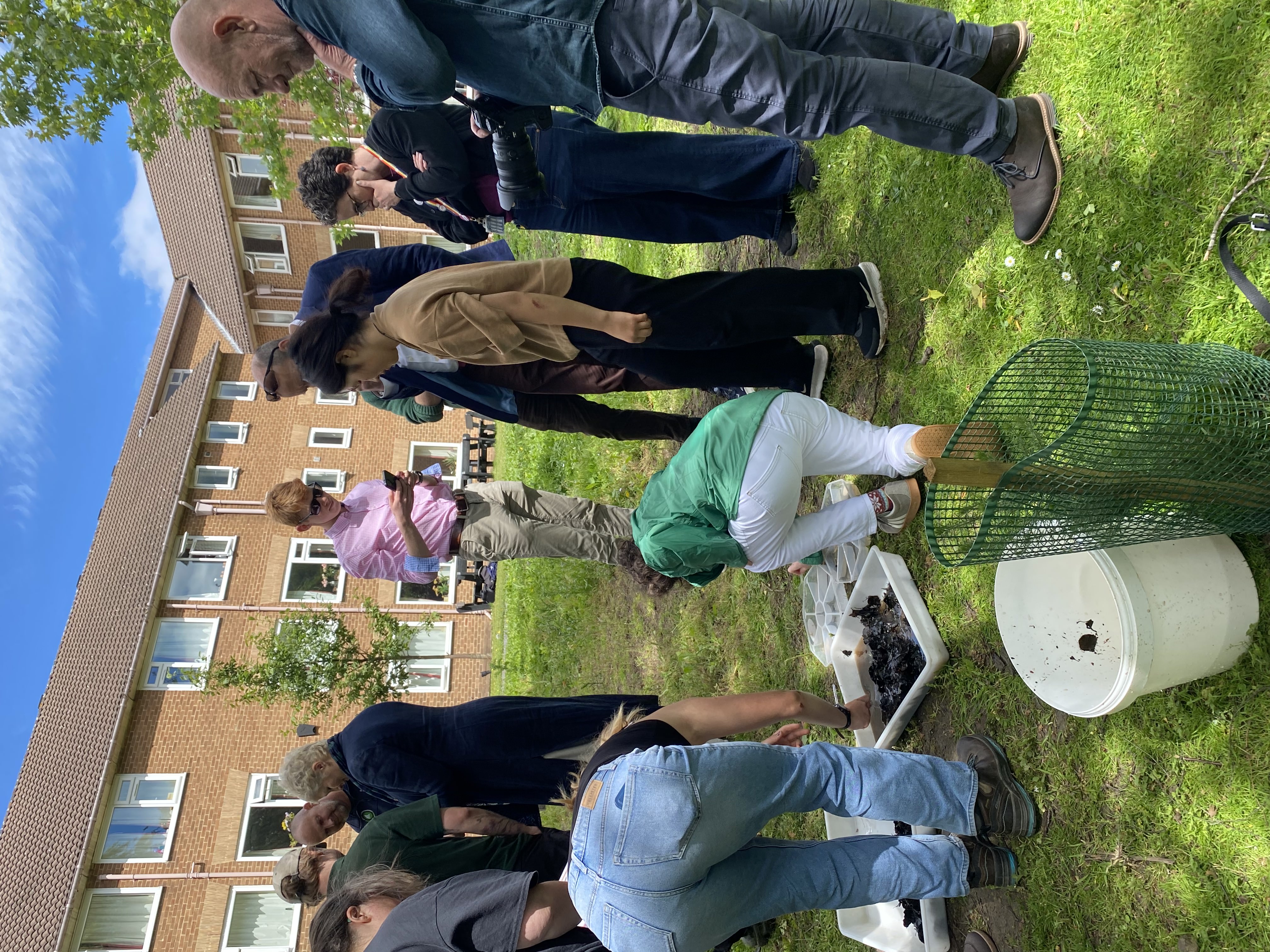 Students and staff inspecting the wildlife in the new biodiversity pond