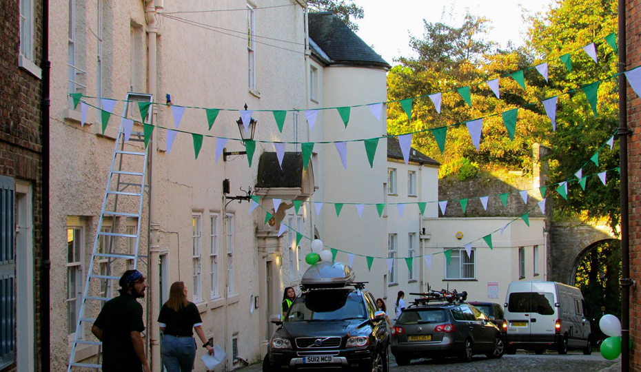 The street where Cuth's is situated on the Bailey. Bunting and cars visible as new students arrive.