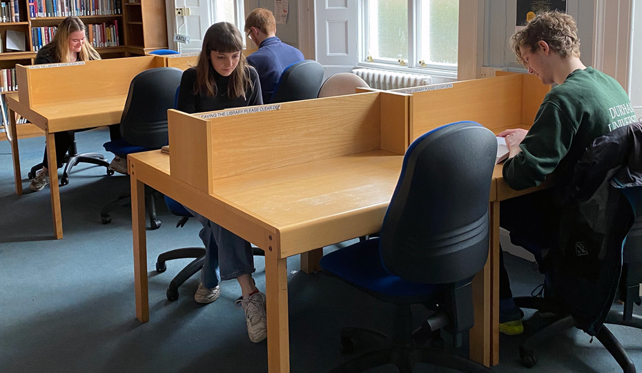 Students studying at individual booth-type desks.