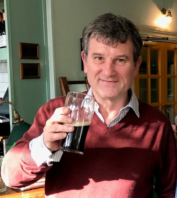 A man rises a pint