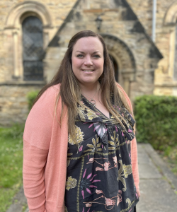 Sarah Strand to waist in floral top and pink cardigan