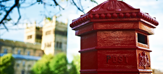 Red postbox with Durham Cathedral in the background