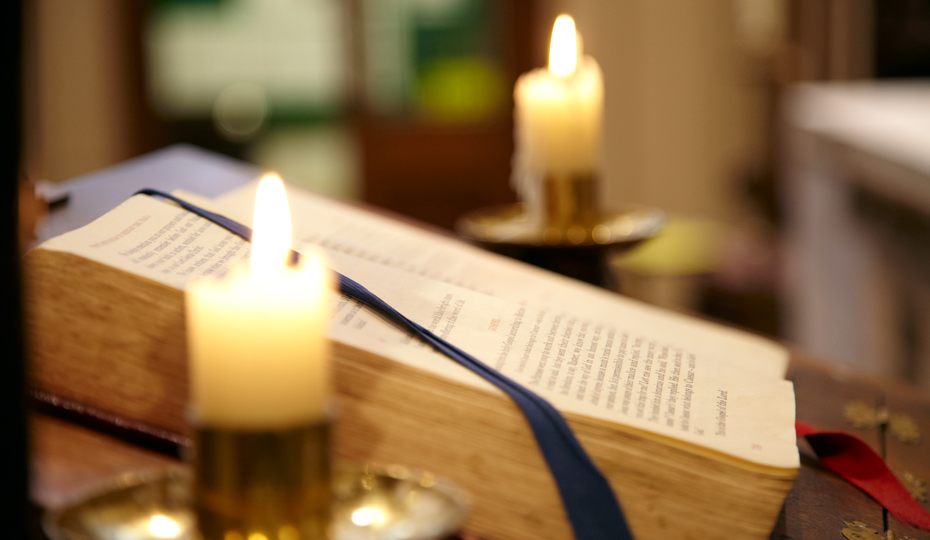 Candlelit books of worship in the University Chaplaincy