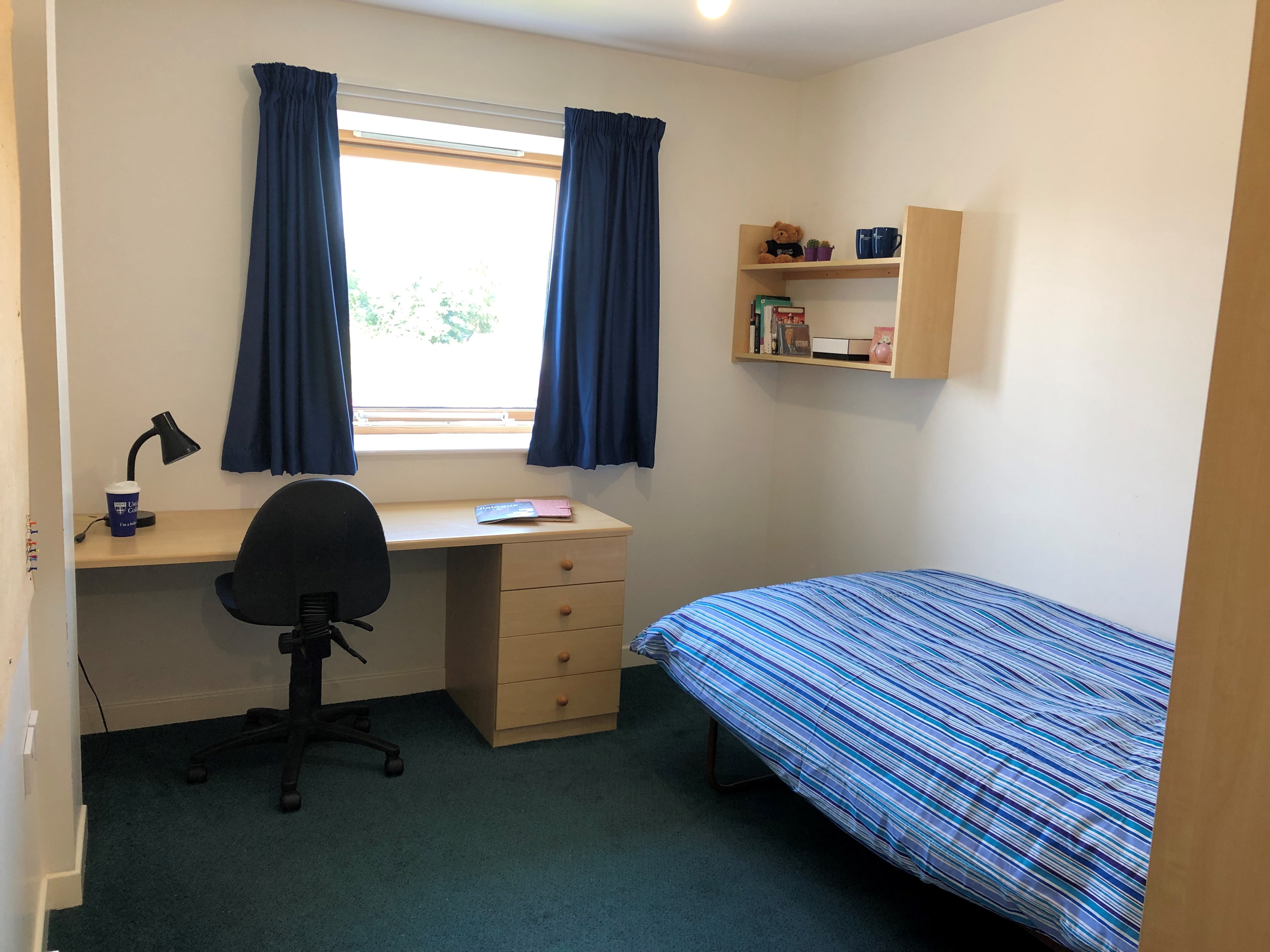 Brakenbury Bedroom with desk, desk chair, wall shelves and single bed