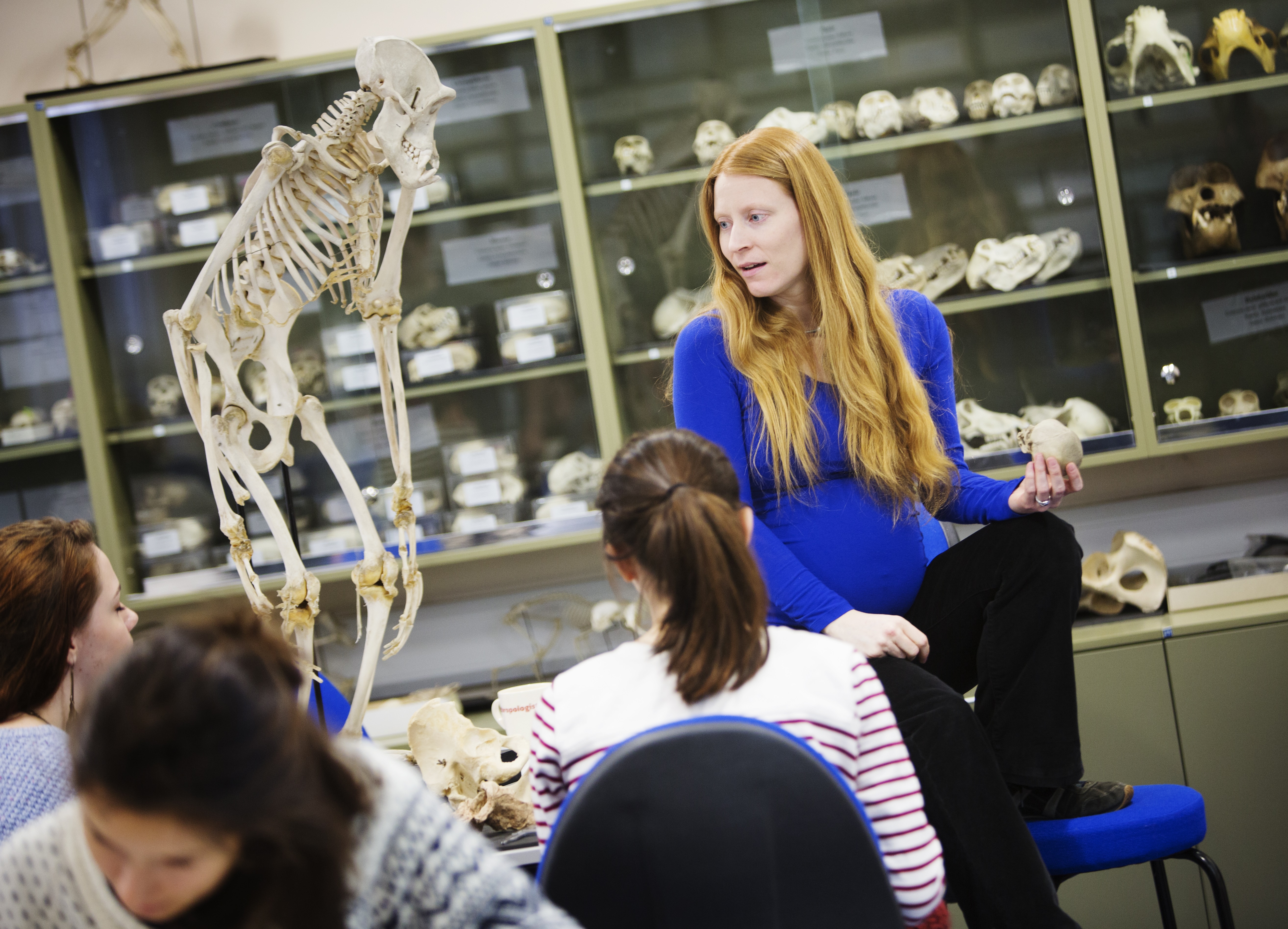 Tutor and students studying bones