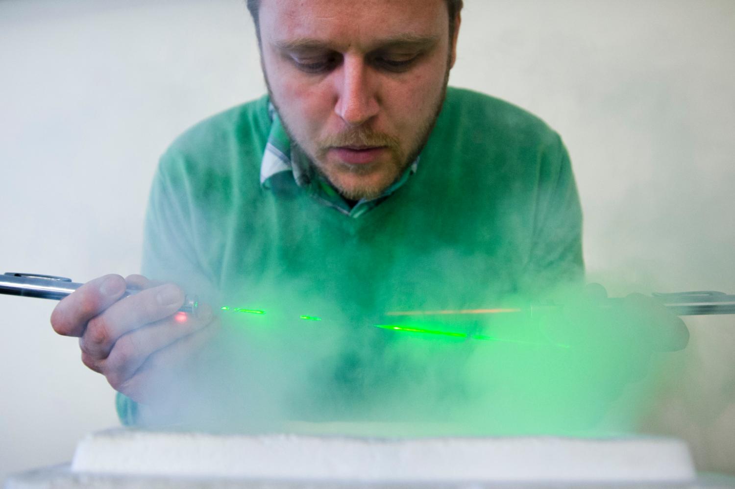 A man with green lasers or gases