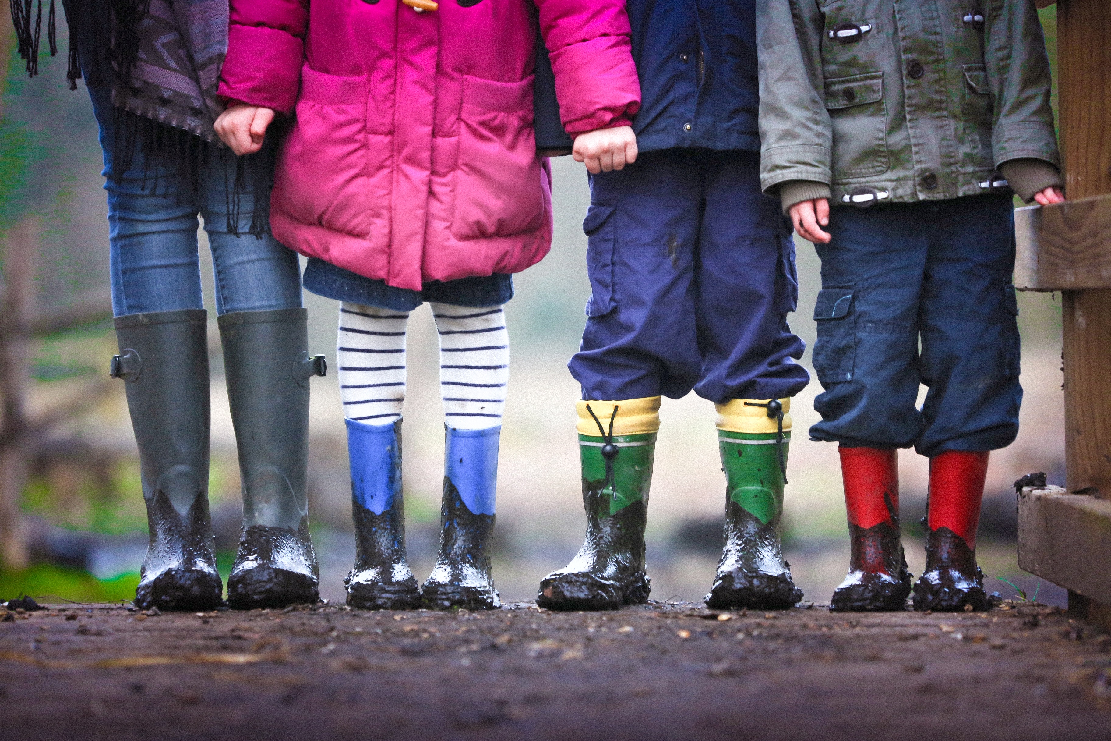 A row of people wearing wellies