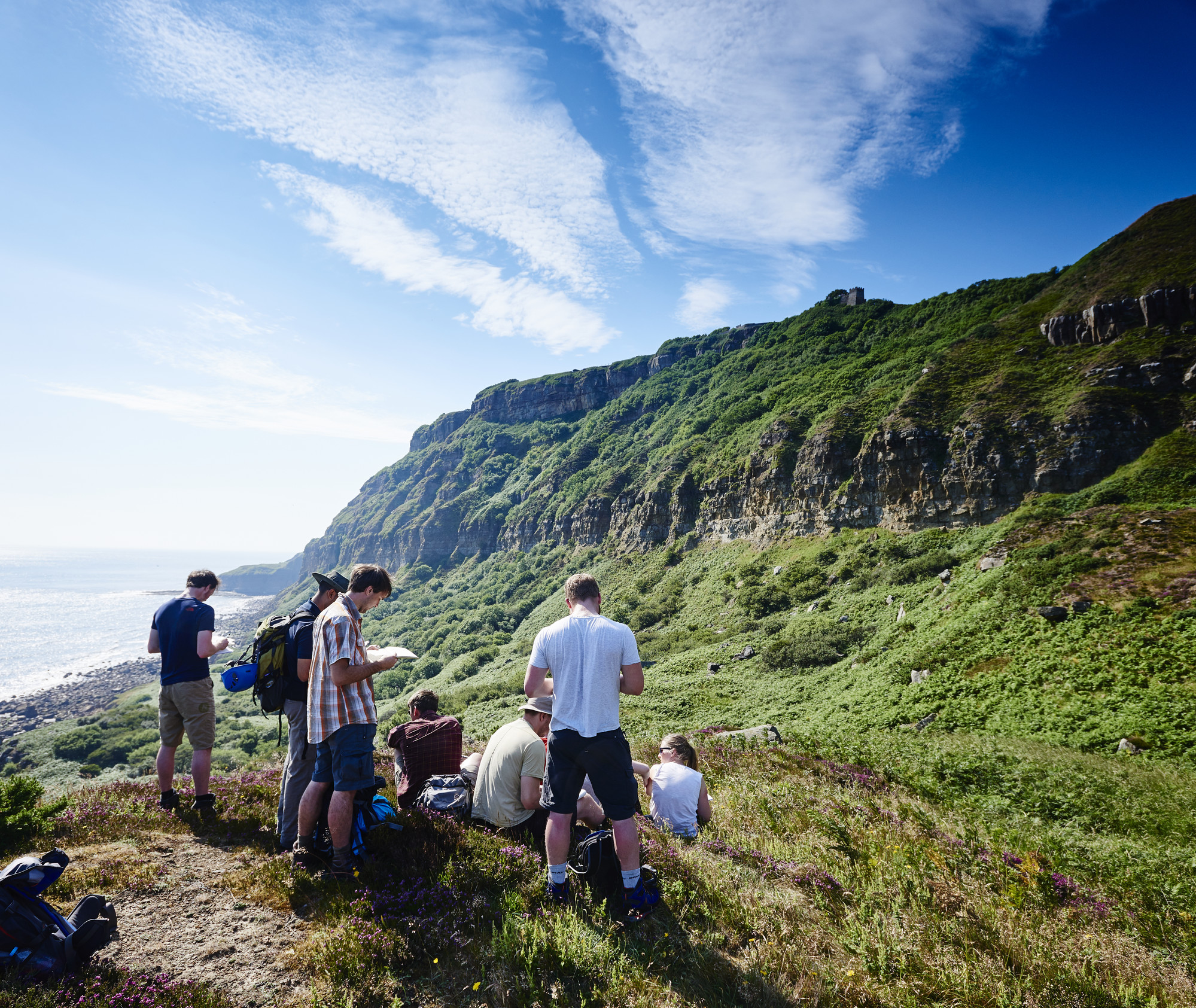 People sat near a cliff