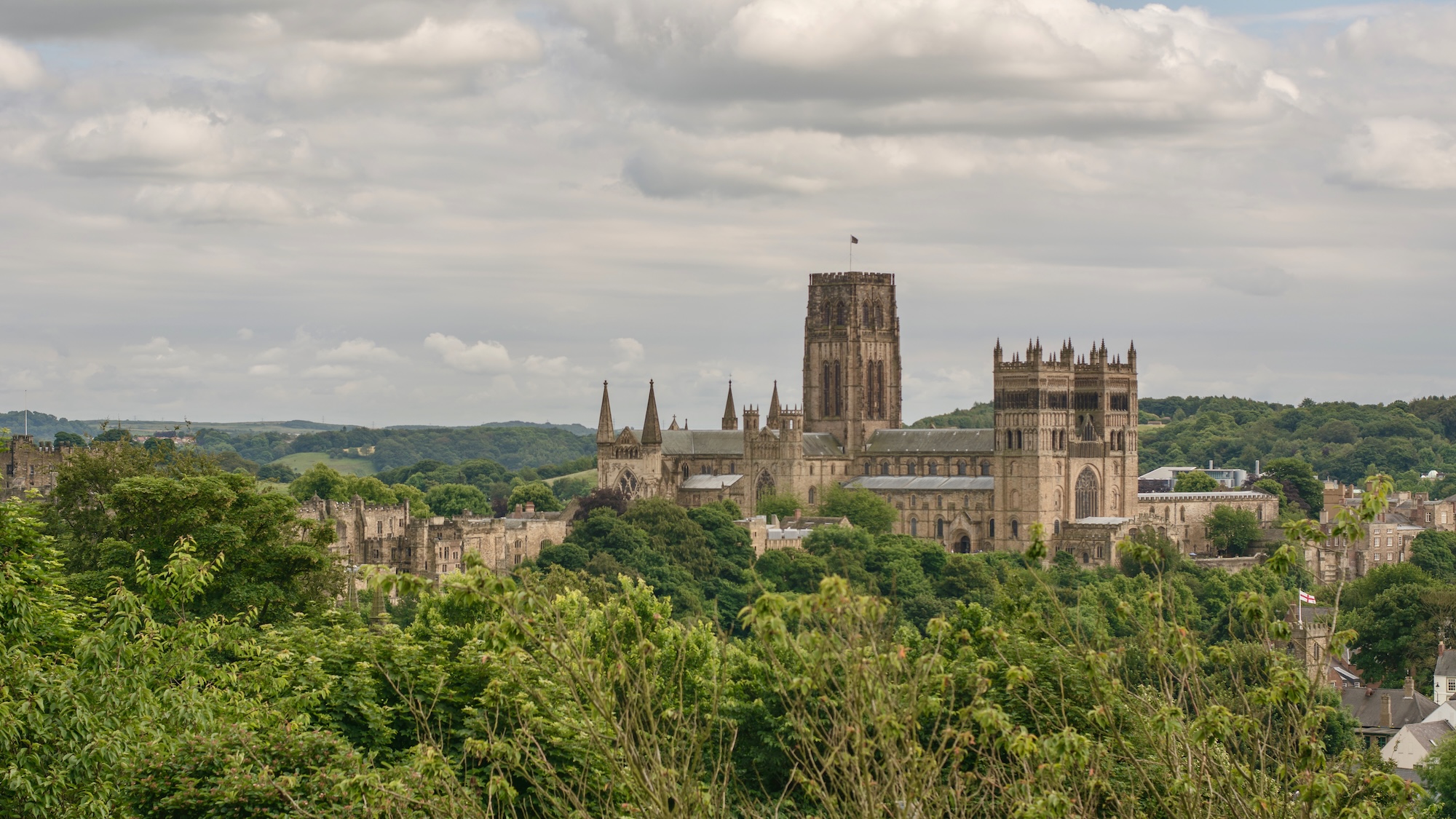 Photograph of Durham cathedral and castle with tress in the forground