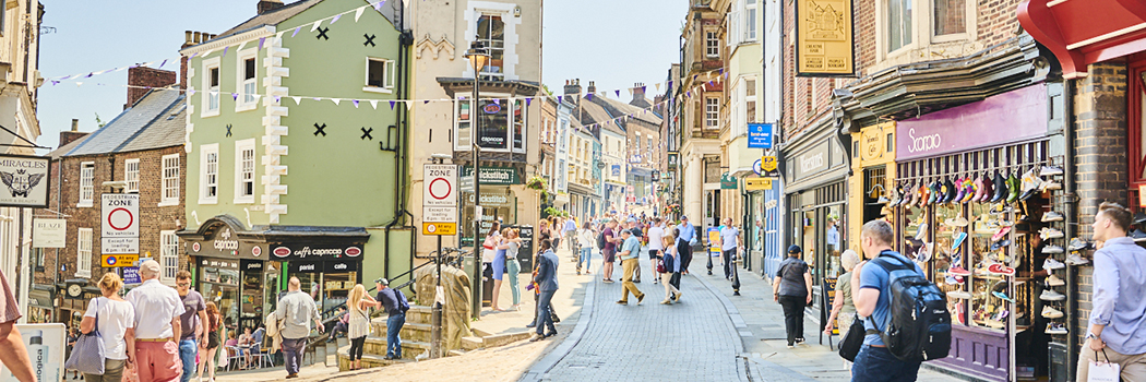 Members of the public walking along Saddler Street in Durham