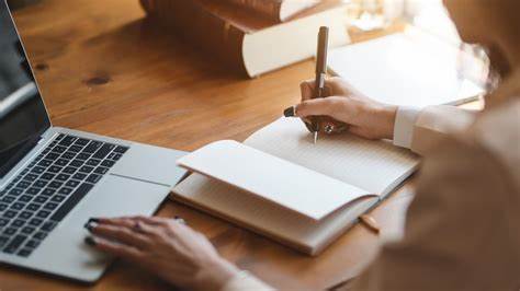 someone writing in a notepad