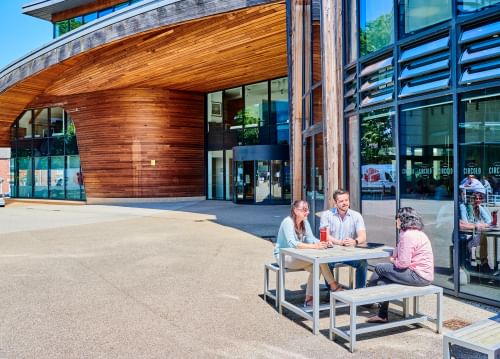A group of people sat at a table outside