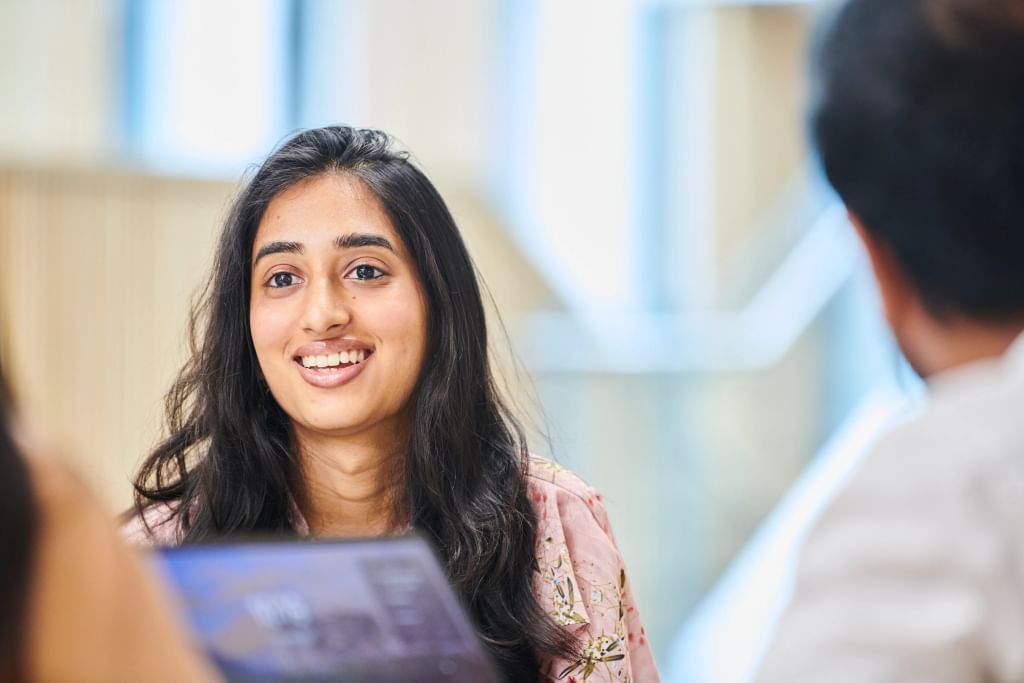 A student sitting at a table with a laptop.