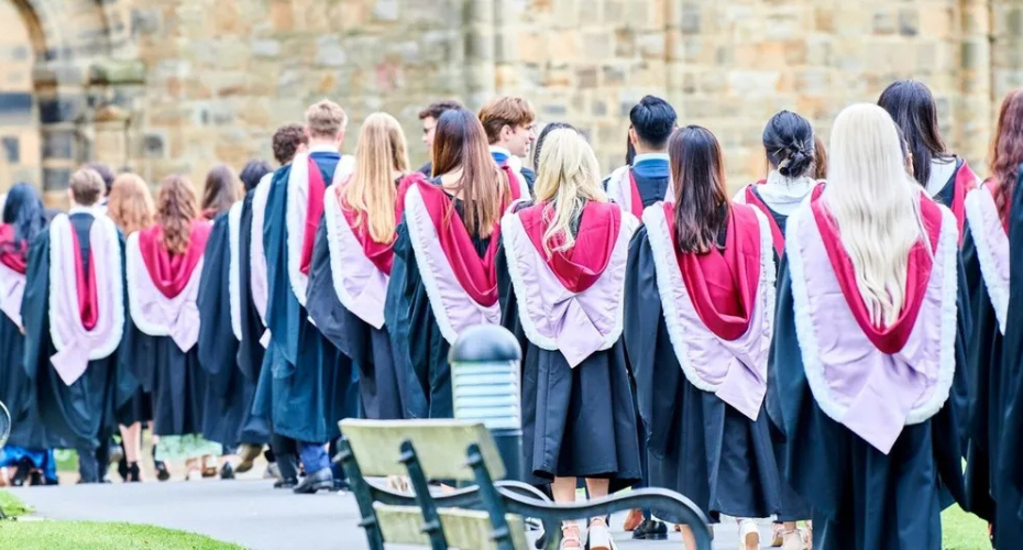 Gowned students entering cathedral