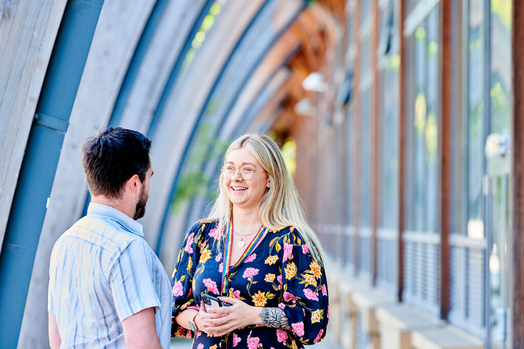 A female and a male member of staff talking to each other at the Palatine Centre.