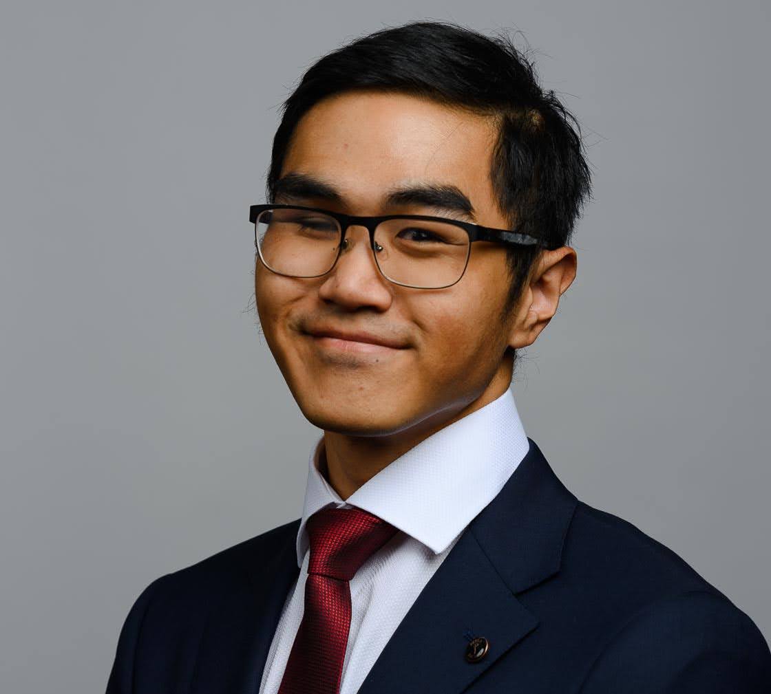 A head shot of a man in glasses