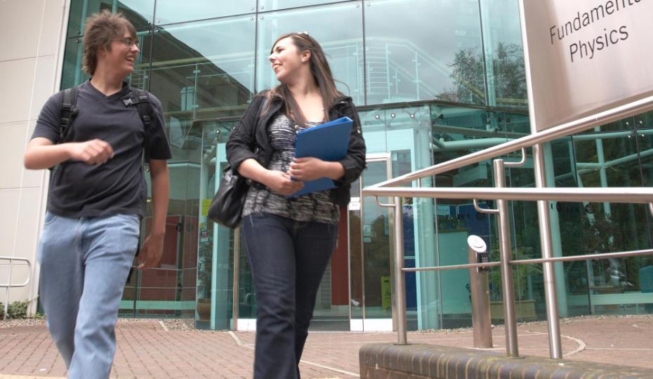 2 students walking out of Ogden Centre and chatting